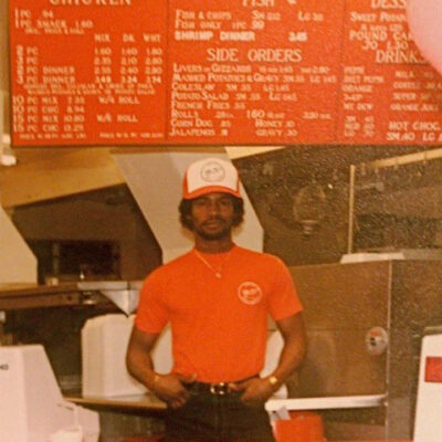 Team member in front of menu